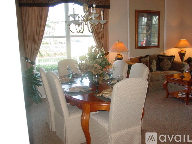 A dining room with a table set for a meal.