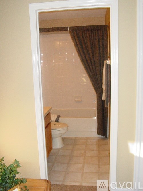 A bathroom with a toilet, sink, and bathtub.