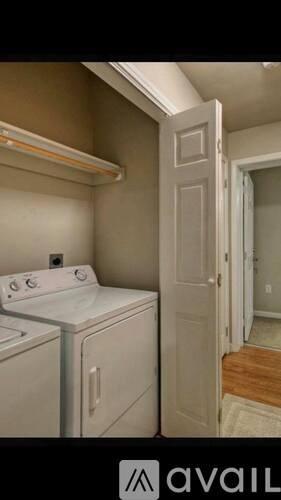 A white washing machine and dryer in a small laundry room.