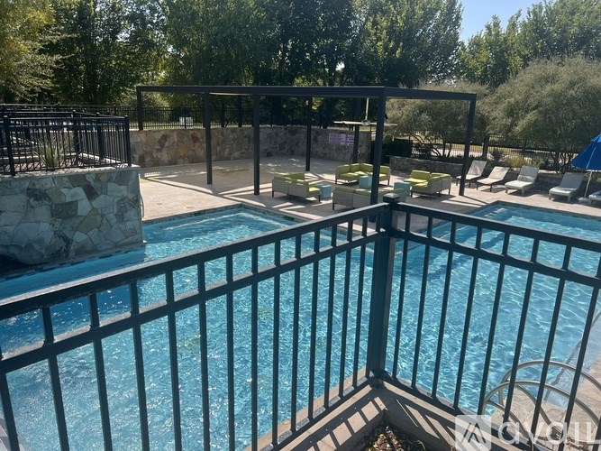 A pool surrounded by a black fence.