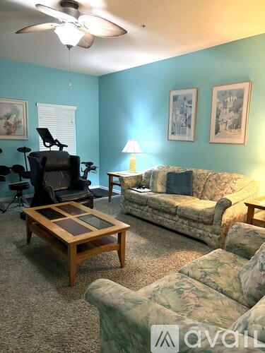 A living room with a couch, chair, and coffee table.