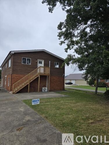 A two-story house with a balcony on the upper floor is for sale.
