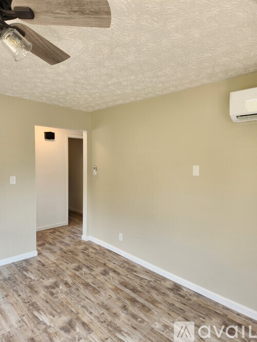 A room with a ceiling fan and light fixture.