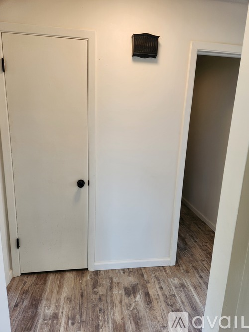 A white door with a black handle is closed.