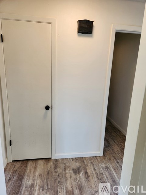 A white door with a black handle is closed.