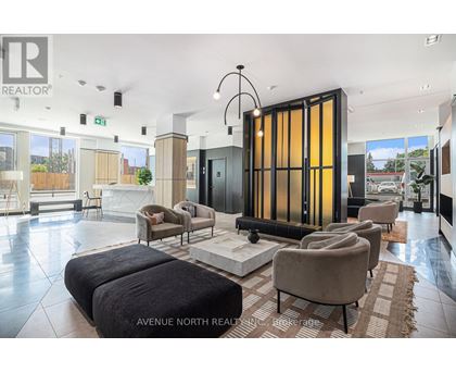 A modern living room with a large sofa set and a glass door.