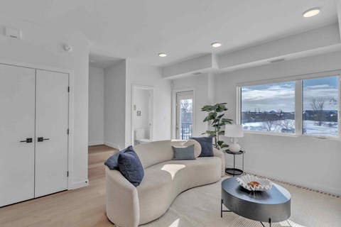 A modern living room with a white couch and a coffee table.