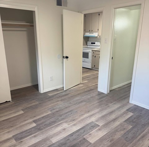 A kitchen with a microwave, oven, and cabinets.