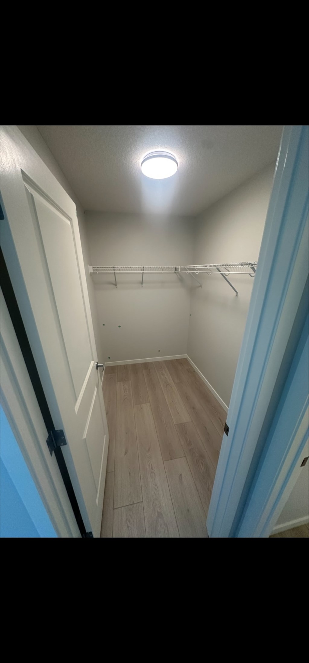 A small, empty room with a light on the ceiling.