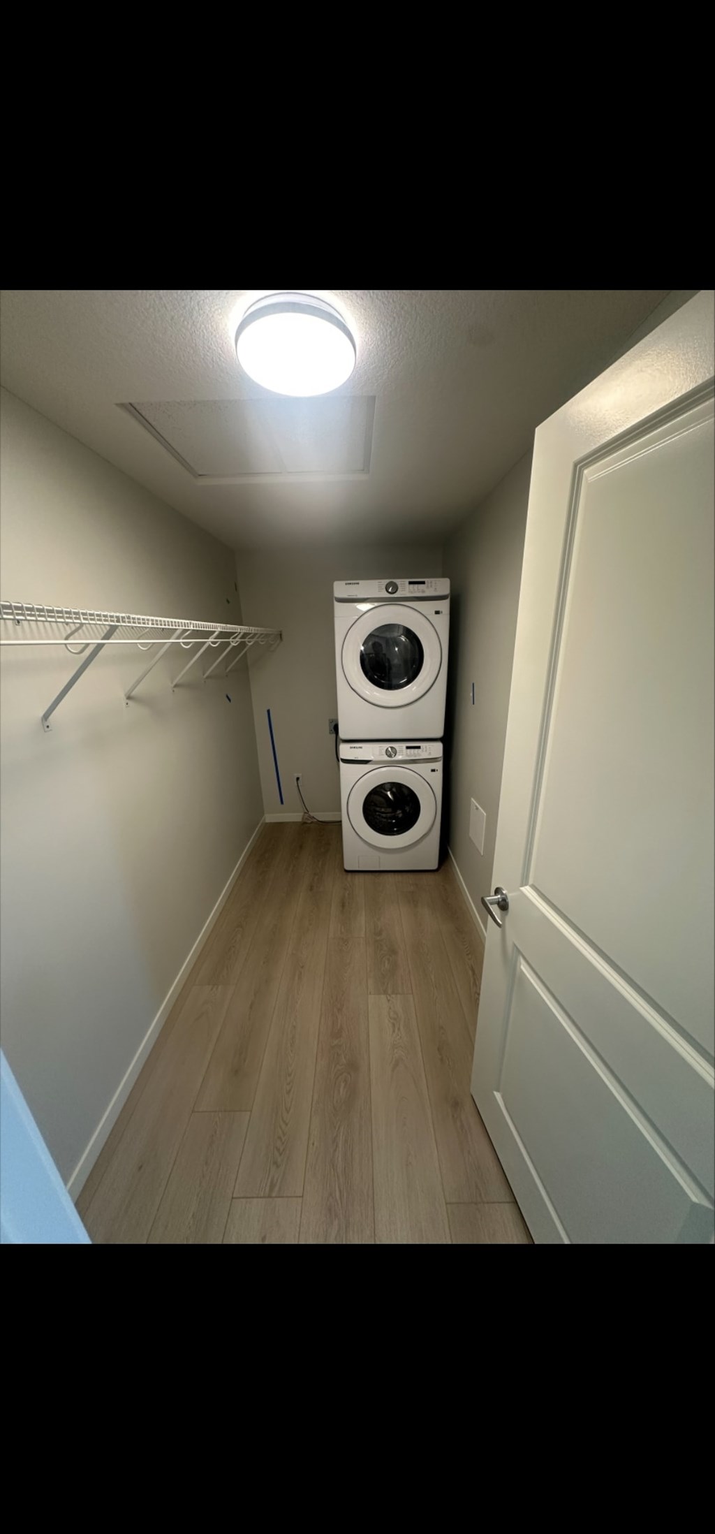 A small laundry room with a washer and dryer.