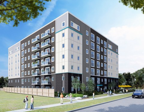 A modern apartment building with balconies and a blue stripe on the side.