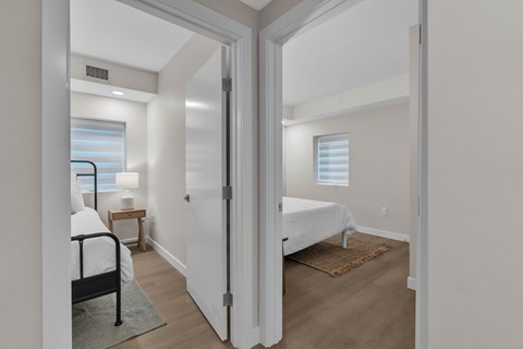 A bedroom with a bed, nightstand, and window.