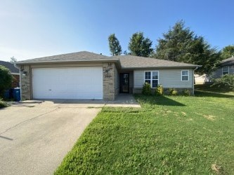 A house with a garage door and a driveway.