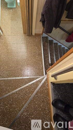 A hallway with a brown floor and a white line painted on it.