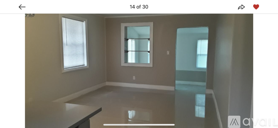 A room with a large window and a glass table.