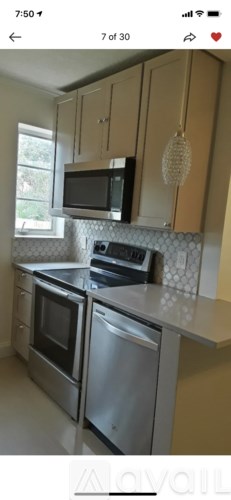 A kitchen with a stove top oven and microwave.