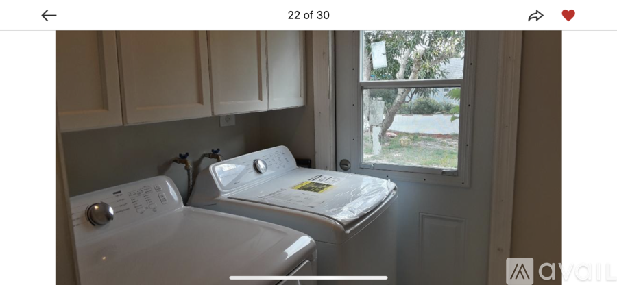 A white washing machine and dryer in a small laundry room.
