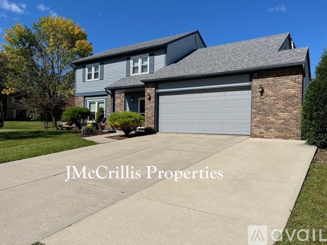 A house with a garage door is for sale by JMcCrillis Properties.
