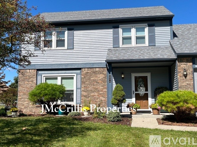 A house with a front yard and a sign that says "JM Crill Properties".