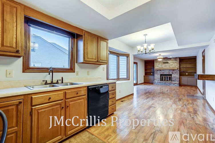 A kitchen with wooden cabinets and a large island.