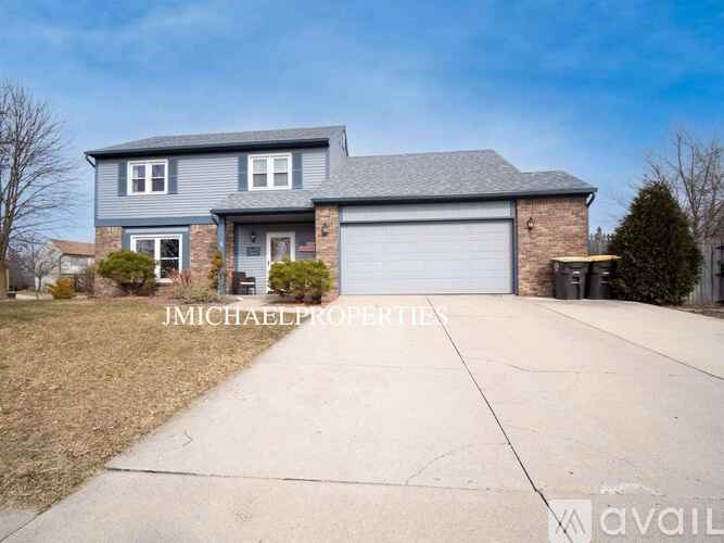 A two-story house with a garage is for sale.