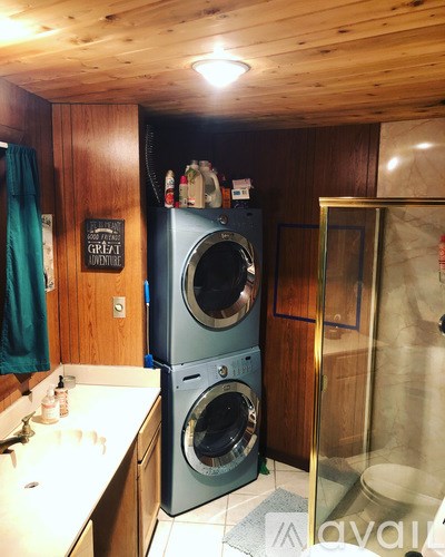 A wooden cabinets with a washing machine and a sign that says "Great Adventure".