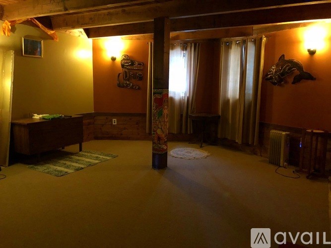 A room with orange walls and a wooden floor.