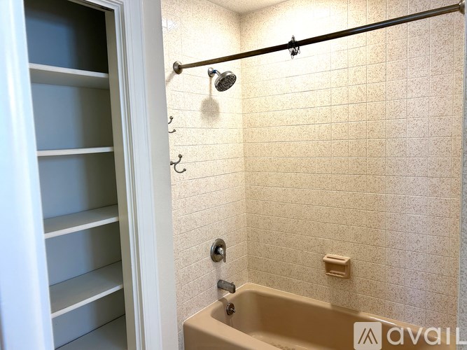 A bathroom with a tub and a shower.