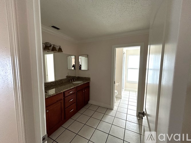 A bathroom with a sink and mirror.