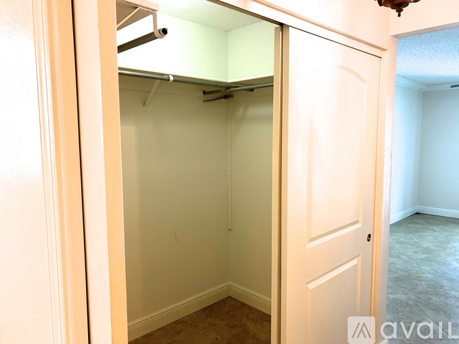 A small, empty room with a door and a window.