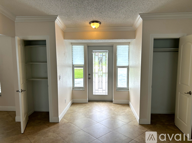 A kitchen with white cabinets and granite countertops.