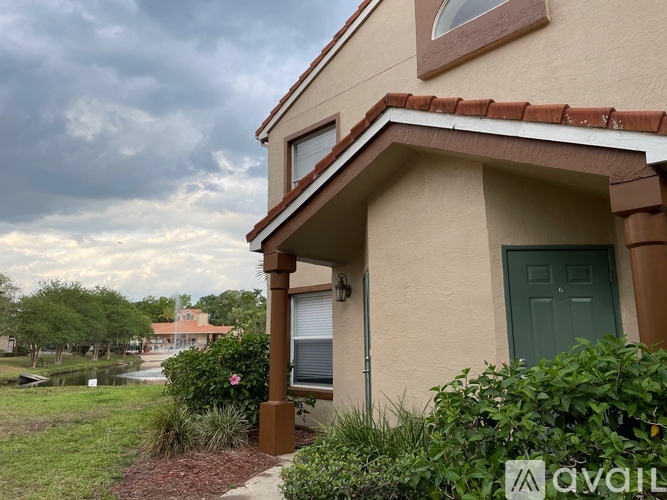 A house with a green door and a sign that says "available" in front of it.