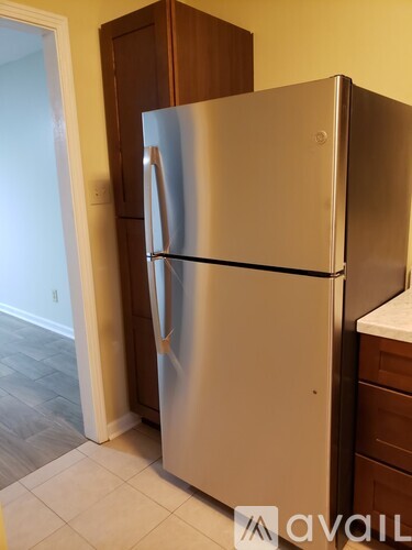 A stainless steel refrigerator in a kitchen.
