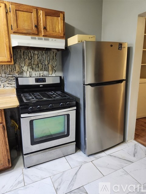 A kitchen with a stove and refrigerator.