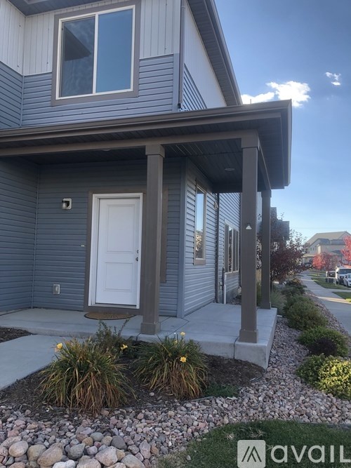 A house with a white door and a small porch.