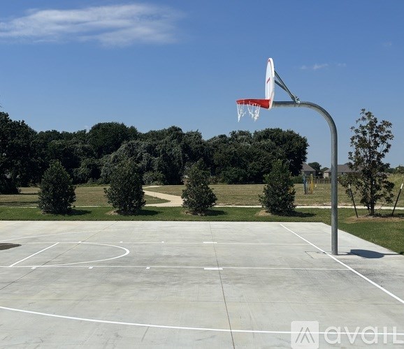 A basketball court with a hoop and a backboard.