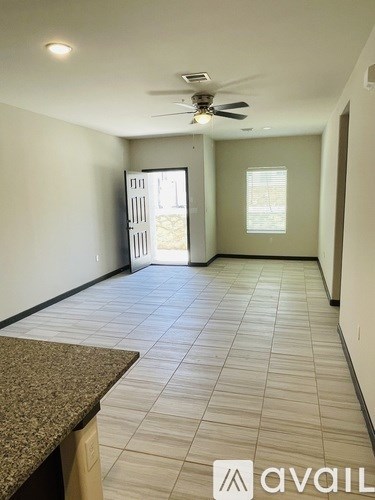 A room with a ceiling fan and a window.