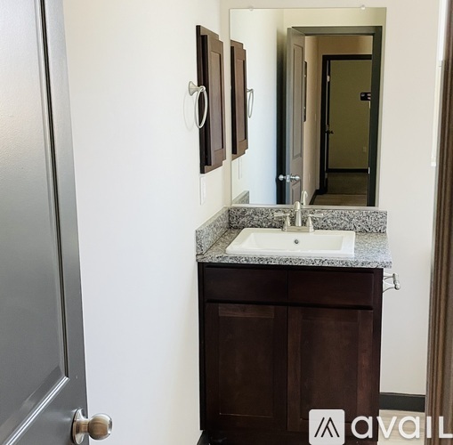 A bathroom with a sink and a mirror above it.