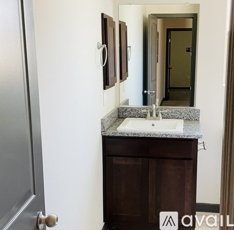 A bathroom with a sink and a mirror above it.