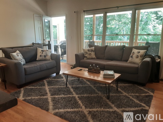 A living room with two grey couches and a coffee table.