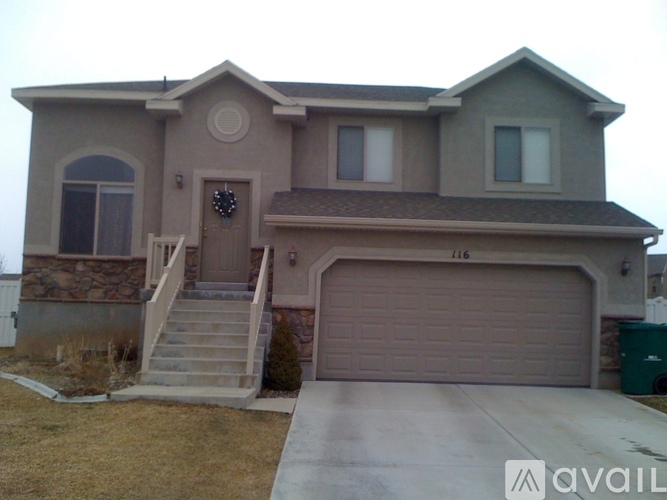 A house with a garage and a driveway in front.
