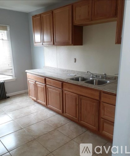 A kitchen with brown cabinets and a white countertop.
