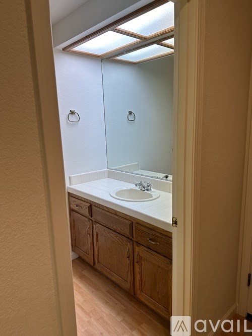 A bathroom with a sink and a mirror.