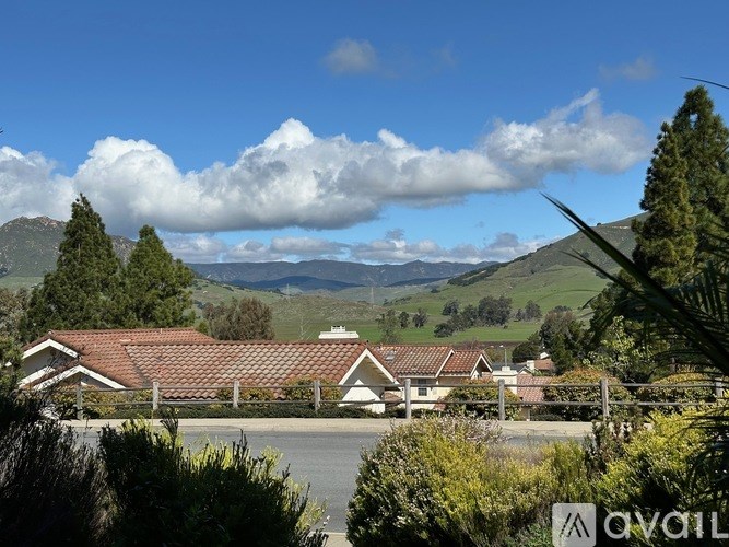 A suburban area with houses and a mountain range in the background.