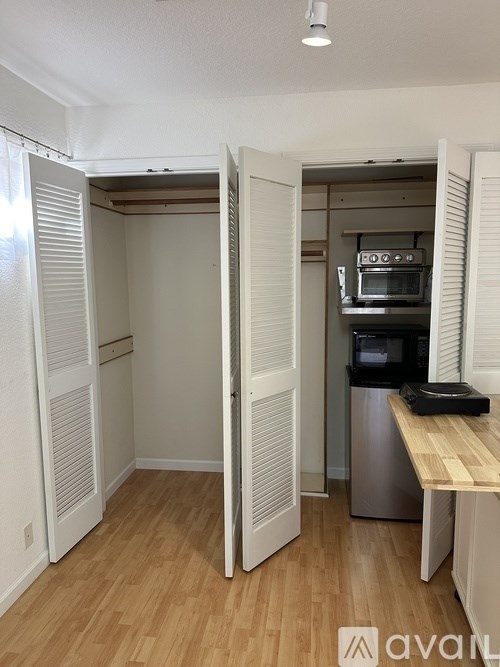 A kitchen with a wooden counter and a stainless steel dishwasher.