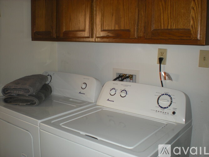 A white washing machine with a towel on top of it.
