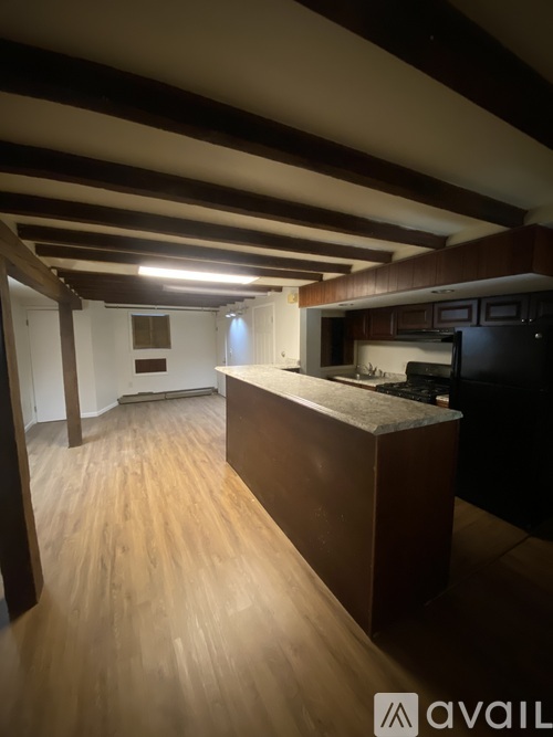 A kitchen with wooden floors and a large island.