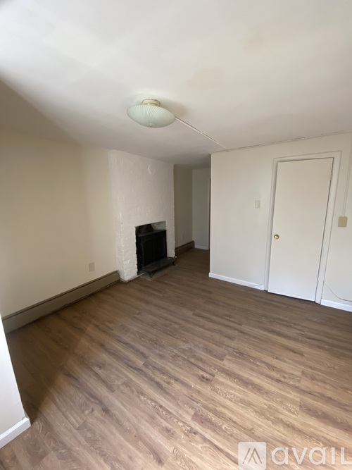 A room with a wooden floor and a white ceiling.