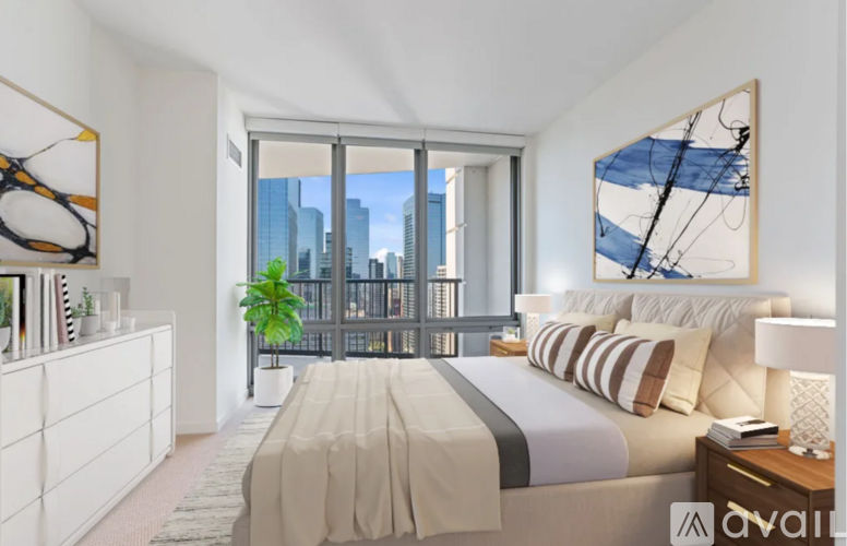 A bedroom with a large bed and a view of the city.