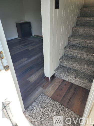 A staircase with a carpeted bottom step.